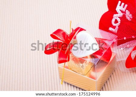 Valentine decoration, heart shaped chocolates box with blank card, red heart with love word and red bow