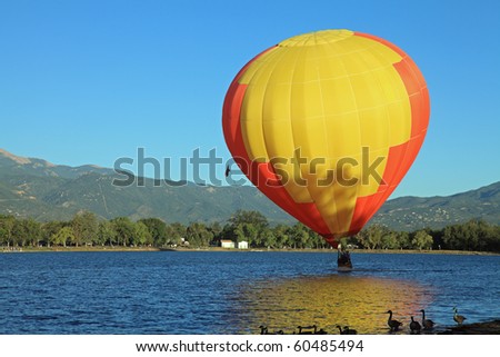 Hot air balloon touching down in water