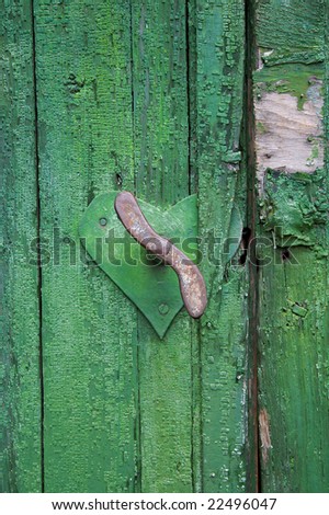 Old rusty handle on the wooden door