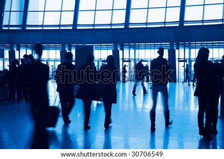 Entrance to modern building and people silhouettes.  Tint blue