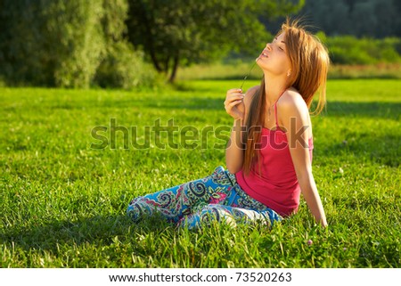 Young beautiful girl with  blade of grass