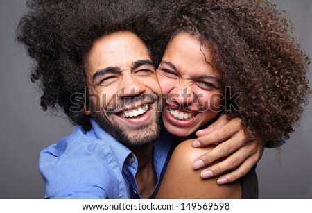 Happy couple doing funny faces in a photo booth