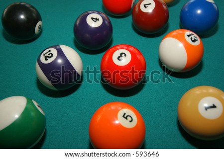 pool balls in play on green felt table