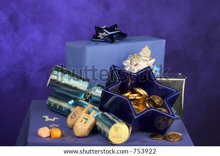 lots of Hanukkah decorations gelt, star of David, packages and dreidels