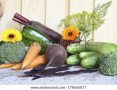 Fresh vegetables against a wooden wall on a grey cloth