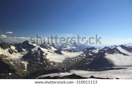 Panorama of mountain peaks in the sun, the majesty and beauty of the world, the Caucasus