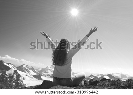 Winning success woman happy with her hands raised above the head in celebration of reaching the top of a mountain during a camping trip, the concept of freedom