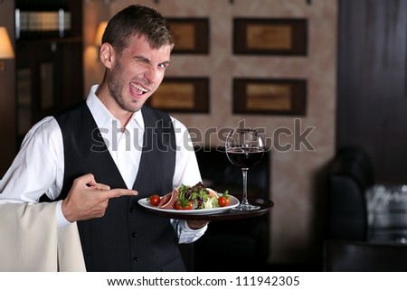 handsome man waiter in uniform at restaurant