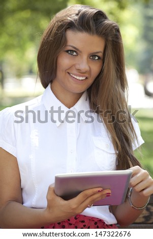 Attractive female business executive busy working on digital tablet