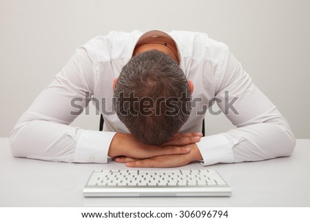 Stressed out businessman. Man frustrated with his computer. Isolated on white background