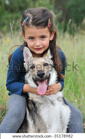 little girl and her baby purebred wolf dog