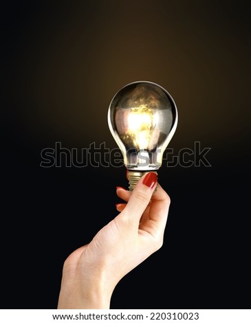 Female Hand Holding Light Bulb