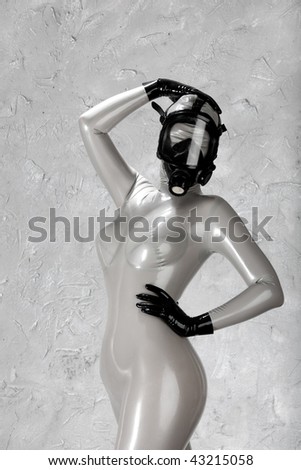 Girl in full latex suit in mask. Fetish concept.