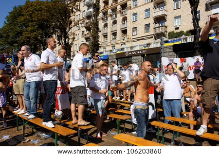 KIEV, UKRAINE - JUNE 24: English people drink beer in Fan-Zone of Euro 2012 on June 24, 2012 in Kiev, Ukraine. The slogan of EURO 2012 Football Championship is \