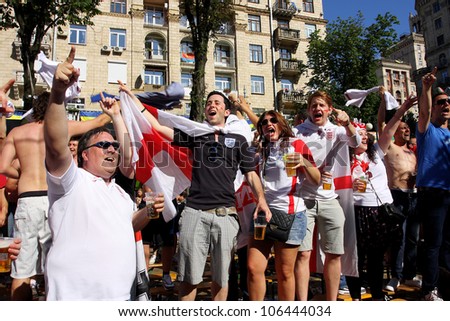 KIEV, UKRAINE - JUNE 24: Women and men from England have fun in Fan-Zone of Euro 2012 on June 24, 2012 in Kiev, Ukraine. The slogan of EURO 2012 Football Championship is \