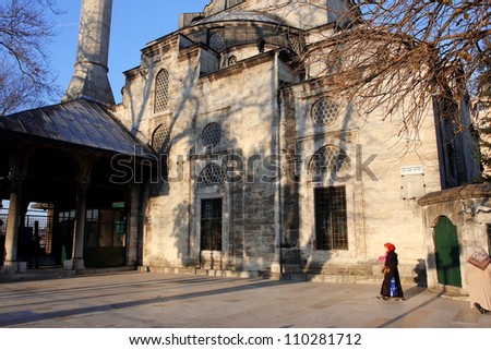 ISTANBUL, TURKEY - JANUARY 21: Women walking near Mihrimah Sultan Mosque at the bright evening on January 21, 2012 in Istanbul, Turkey. The Mihrimah Sultan Mosque was designed by Mimar Sinan in 1562.