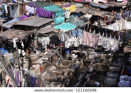 MUMBAI, INDIA - JAN 15: People work at the open-air laundry Dhobi Ghat at the sunny day on 15 January 2010 in Mumbai. It is the the largest outdoor laundry in the world with 700 washing platforms
