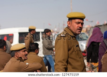 ALLAHABAD, INDIA - JANUARY 26: Indian police officers guard the biggest festival in the world - Kumbh Mela, on January 26, 2013 in Allahabad, India. It is held every 12 years on the banks of Sangam