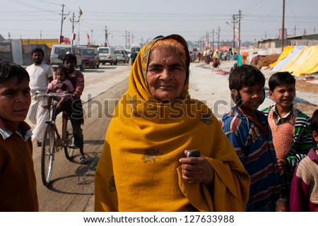 ALLAHABAD, INDIA - JAN 29: Elderly indian woman on the street during celebration of holy Kumbh Mela, on January 29, 2013 in Allahabad, India. Festival Kumbh Mela 2013 will take 130 000000 visitors.