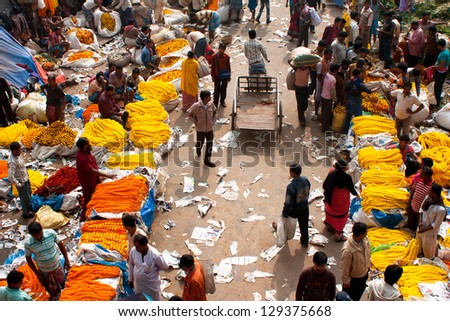 KOLKATA, INDIA - JAN 11: Crowd of people buy & sell flowers in Mullik Ghat Flower Market on January 11, 2013. The market is more than 125 years old. More than 2000 sellers work in the market every day