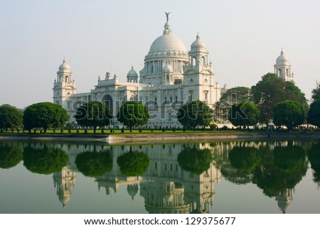 Reflection of the white building Victoria Memorial in Kolkata, India. The memorial was designed by Sir William Emerson using Indo-Saracenic style.