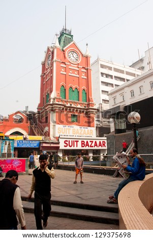 KOLKATA, INDIA - JANUARY 21: Clock tower of the historical building New Market and people around on January 14, 2013 in Kolkata, India. New Market was open with fanfare to the English populace in 1874