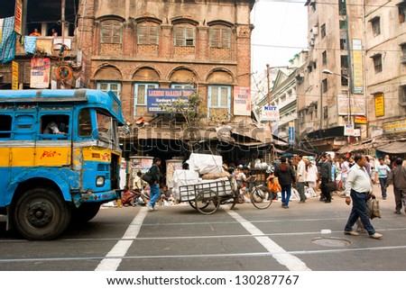 KOLKATA, INDIA - JANUARY 13: People and transport traffic on the asian street on January 13, 2013 in Kolkata, India. Kolkata has a density of 814.80 vehicles per km road length