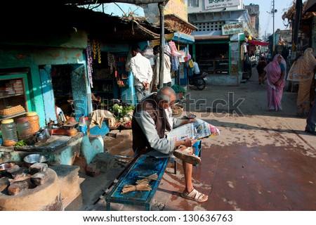 CHITRAKOOT, INDIA - DEC 29: Old asian man reading a morning newspaper on December 29 2012 in Chitrakoot India. Chitrakoot has an average literacy rate of 50%, lower than the national average of 59.5%