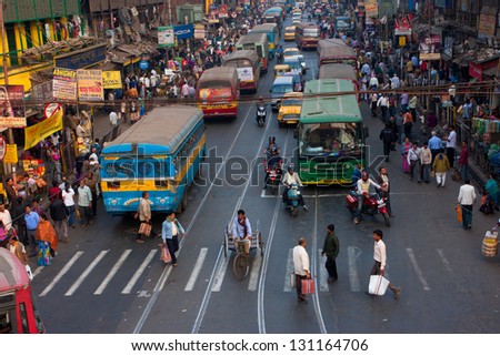 KOLKATA, INDIA - JANUARY 18: Big city street with thousands of people, bikes and the buses on January 18, 2013 in Kolkata, India. Kolkata has a density of 814.80 vehicles per km road length.