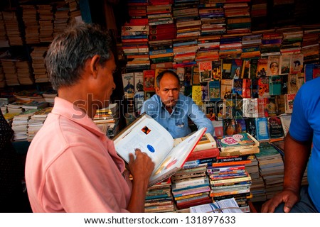 KOLKATA, INDIA - JAN 15: Customer and book trader on the asian street market on January 15, 2012 in Kolkata. From 1976 Kolkata have the Book Fair with 2 million visitors annual