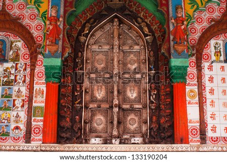 UTTAR PRADESH, INDIA - JAN 27: Beautiful metal doors of the Hanuman temple framed by colorful figures, patterns and drawings on January 27 2013 in Ayodhya India. Uttar Pradesh state covers 243,290 km2