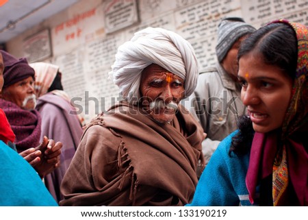 UTTAR PRADESH, INDIA - JAN 21: Indian senior makes his way through the crowd in a temple on January 21, 2013 in Ayodhya, India. Uttar Pradesh is the 5th indian largest state, with 200 mill. people