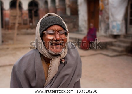 AYODHYA, INDIA - JAN 27: Poor elderly man in vintage glasses walk the street on January 27, 2013, in Ayodhya, India. 60-plus age group in India will increase to 100 million people in 2013.