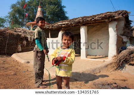 CHITRAKOOT, INDIA - DEC 29: Unidentified children play outdoor near the mud village houses on December 29, 2012 in Chitrakoott, Madhya Pradesh, India. Madhya Pradesh state has 105,592 primary schools