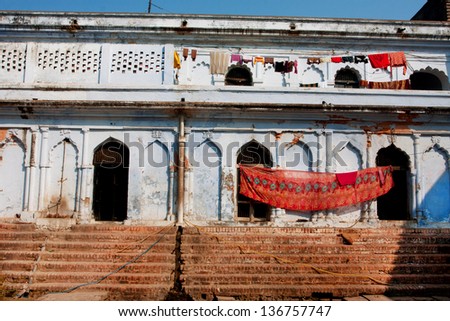 Ethnic clothes dried in the sun on the outside of an ancient Indian home