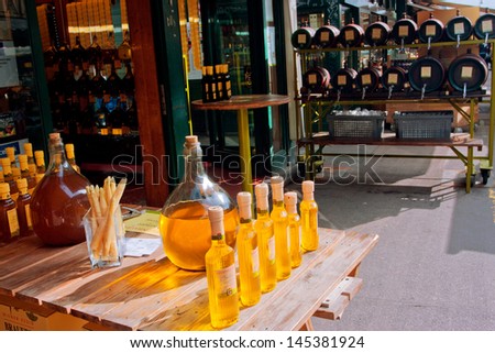 VIENNA - JUNE 6: Large bottles of vinegar by popular austrian plant in the the small shop of market Naschmarkt on June 6, 2013 in Vienna, Austria. The popular Naschmarkt has existed since 16th century