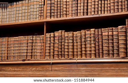 VIENNA - JUNE 1: Ancient books volumes stuck in a shelf of the old Austrian National Library on June 1 2013 in Austria. The largest library in Austria with 7.4 million items in its various collections