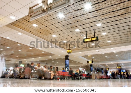 DUBAI - FEB 02: Crowd of the passengers inside the terminal of Dubai International airport on February 2, 2013 in Dubai, UAE. The 3rd busiest airport in the world by international passenger traffic