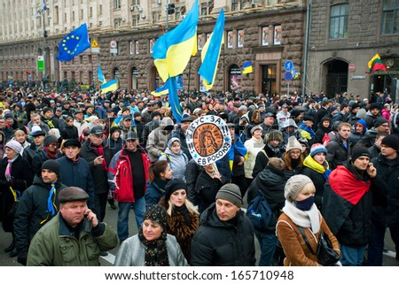 KYIV, UKRAINE - DEC 1: Global crowd of men and women with different flags and anti-government bunners walking down the street during the pro-European protest on December 1, 2013 in Kiev, Ukraine