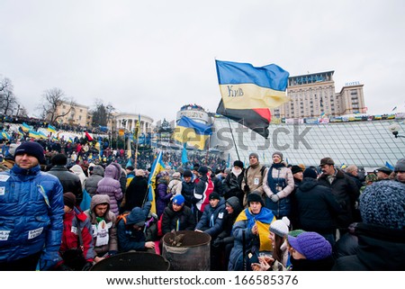 KYIV, UKRAINE - DEC 8: Many different protestors with different flags standing on the crowded street during two weeks anti-government protest on December 8, 2013, in Kiev, Ukraine.