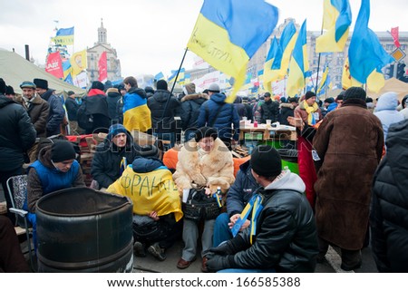KYIV, UKRAINE - DEC 8: Senior woman sitting in the group of the demonstrators on the crowd street during two weeks anti-government protest on December 8, 2013, in Kiev, Ukraine.