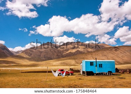 Gypsy caravan belongs the family of farmers lived in the mountains of Central Asia with beautiful white clouds above at the summer time.