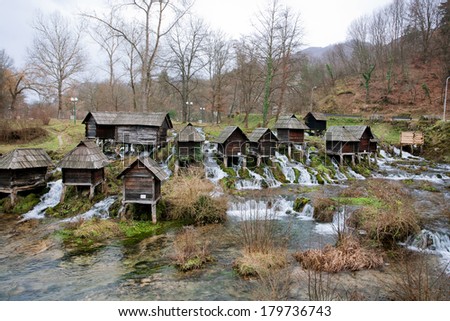 Old wooden water mills built on a fast floting river with clean water in the popular tourist site - historical village near city Jajce in Bosnia and Herzegovina.