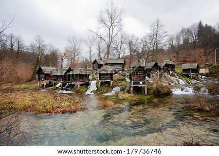 Beautiful spring river with old wooden water mills in ancient historical village near city Jajce in Bosnia and Herzegovina.