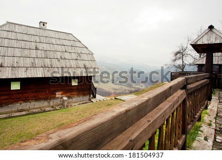 Old village with wooden houses and mountains on the background