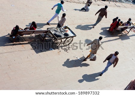 CHITRAKOOT, INDIA - DEC 29: Rashing people walk the wide street with fast food stands at morning on December 29, 2012. Population of indian Chitrakoot is 22,294. By the legend, Lord Rama lived here