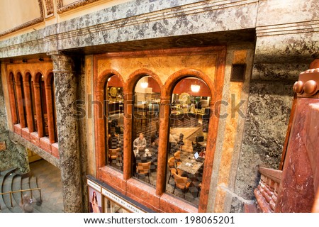 PRAGUE - MAY 16: People sit in cafe inside the historical Lucerna Palace on May 16, 2014 in Czech Republic. Lucerna Palace is Art Nouveau building built in 1921 by former President Vaclav Havel family