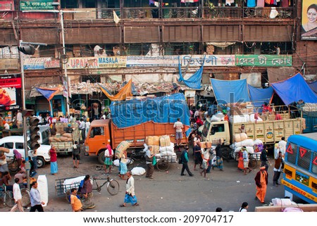 KOLKATA, INDIA - JAN 18: Street view from above on the crowd of rushing people and vehicles on January 18, 2013. Kolkata has a density of 814.80 vehicles per km road length