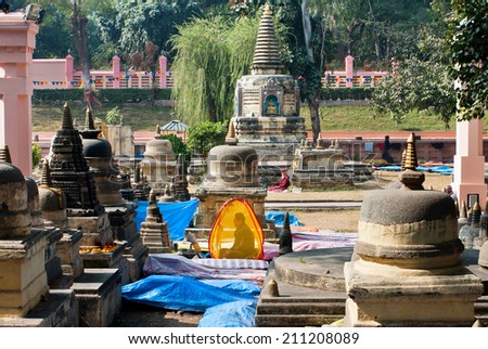 BODH GAYA, INDIA - JAN 9: Lonely man in the tent have a deep meditation in yard of temple on January 9, 2013. Bodh Gaya is 1 of 4 pilgrimage sites related to Buddha, with Kushinagar, Lumbini & Sarnath