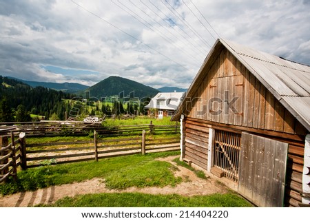 Rural landscape with country house of local farm past the green mountain forests